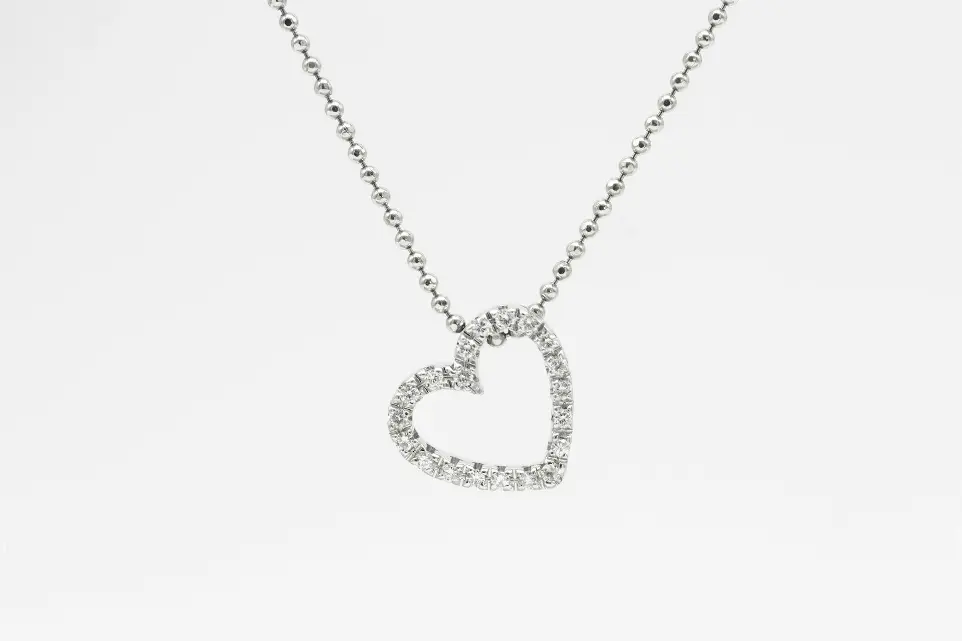 silver heart pendant necklace on white background